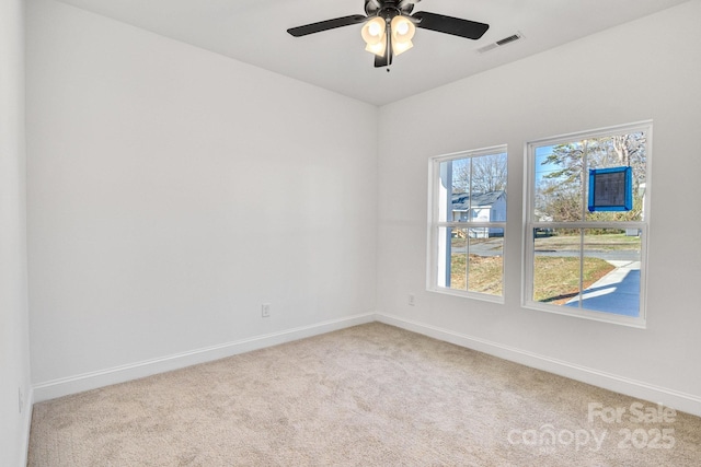 unfurnished room with light colored carpet and ceiling fan