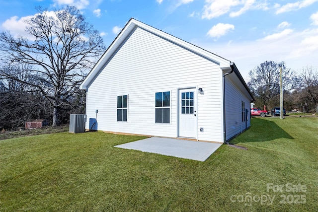 back of house with a lawn, cooling unit, and a patio area