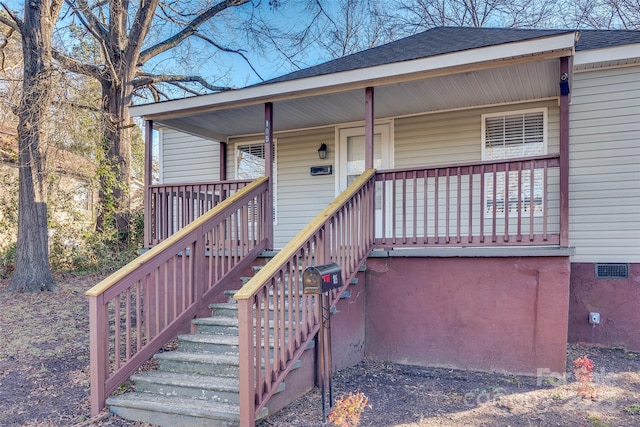 view of exterior entry featuring a porch