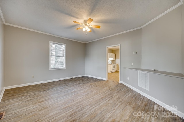 empty room with a textured ceiling, ceiling fan, crown molding, and light hardwood / wood-style floors