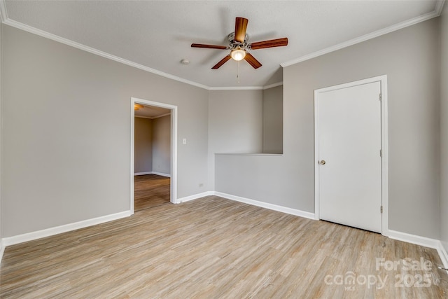 unfurnished room featuring ceiling fan, crown molding, and light hardwood / wood-style flooring