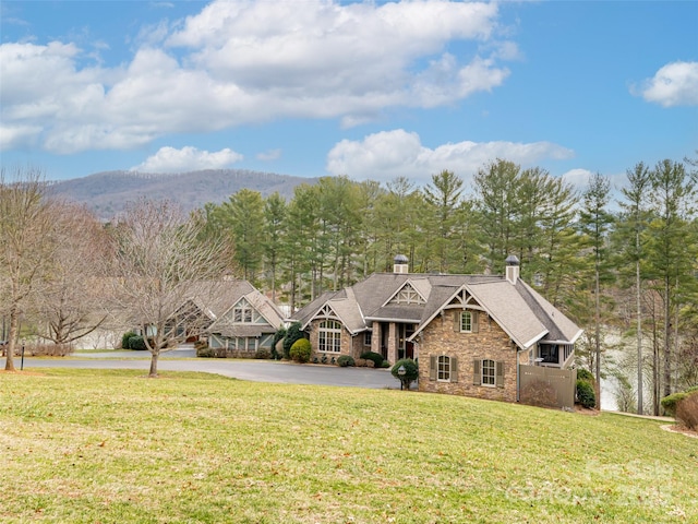 view of front of house with a front lawn and a mountain view