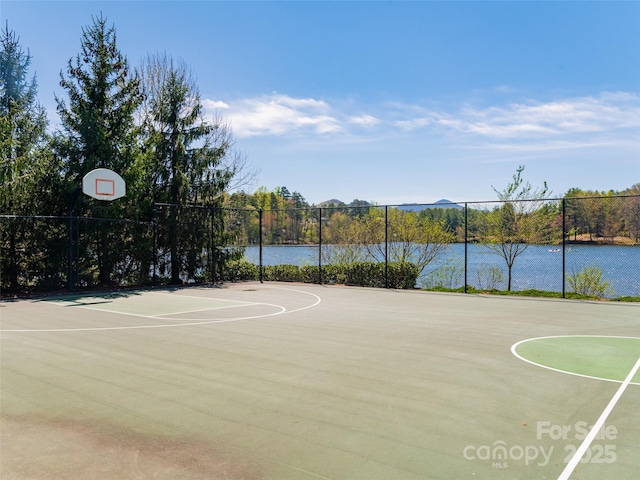 view of sport court with a water view