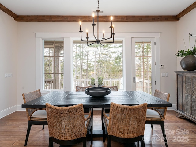 dining area with a notable chandelier and wood-type flooring