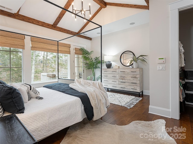 bedroom with dark hardwood / wood-style flooring, an inviting chandelier, and lofted ceiling with beams