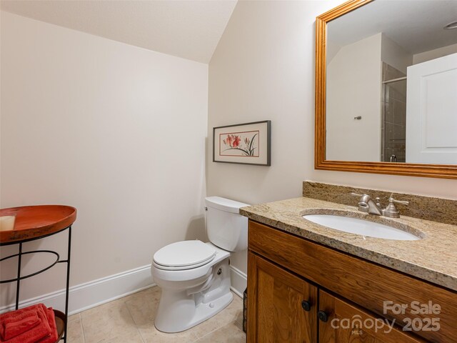 bathroom featuring walk in shower, tile patterned flooring, vanity, and toilet