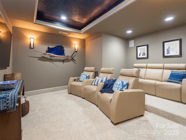 home theater featuring carpet flooring, a tray ceiling, and crown molding