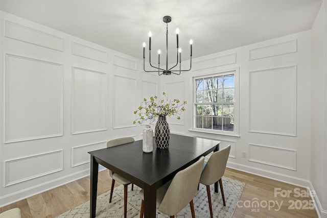 dining area featuring a notable chandelier and light hardwood / wood-style flooring