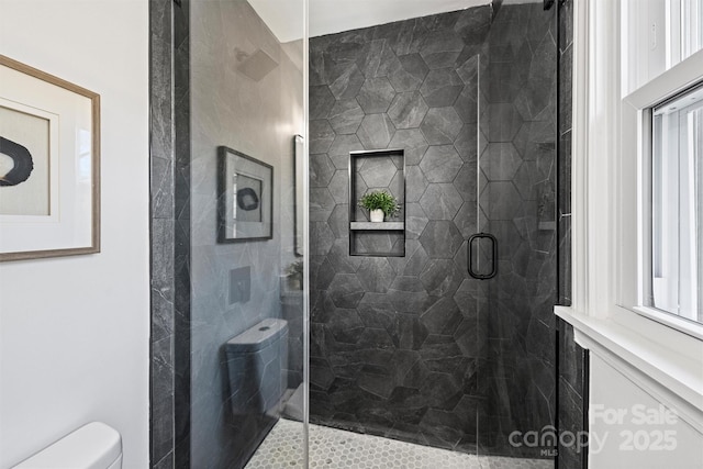 bathroom featuring an enclosed shower and toilet