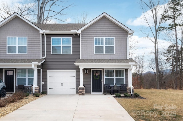 view of front of property featuring a garage and a front lawn