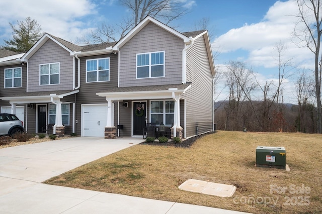 view of front of property featuring a garage and a front lawn