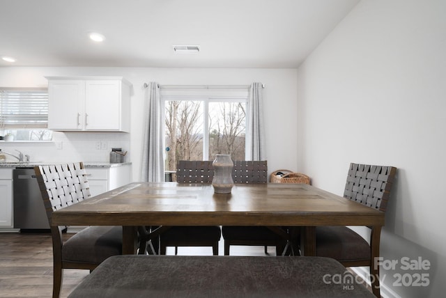 dining room with wood-type flooring and sink