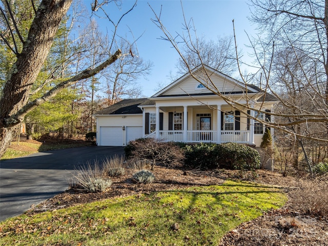 view of front facade with covered porch and a garage