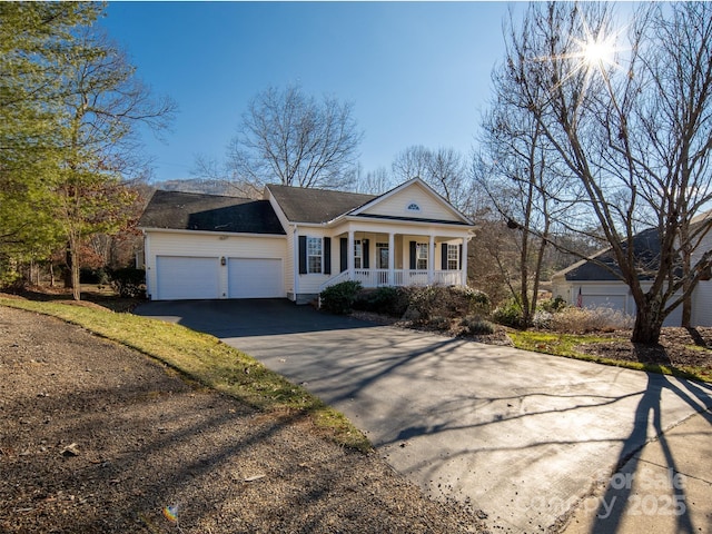 view of front of property with a porch and a garage