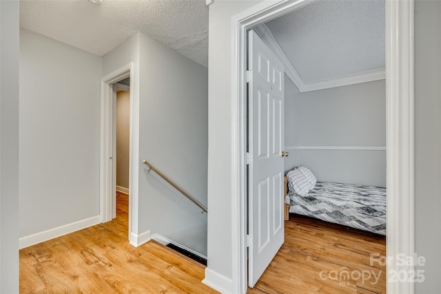 hallway featuring a textured ceiling and wood-type flooring