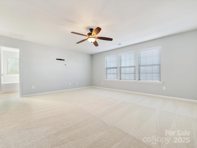 carpeted spare room with ceiling fan