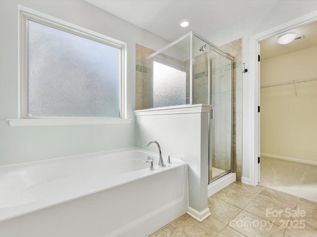 bathroom featuring shower with separate bathtub and tile patterned floors