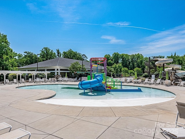 view of pool featuring a water slide and a playground