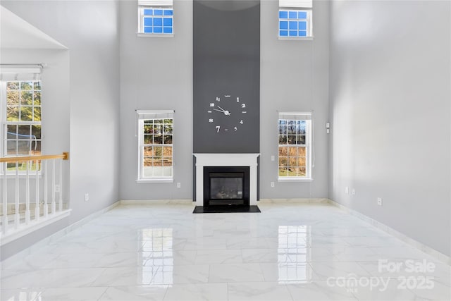 unfurnished living room with a wealth of natural light and a towering ceiling