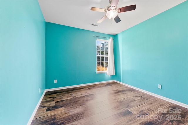 empty room with ceiling fan and hardwood / wood-style floors