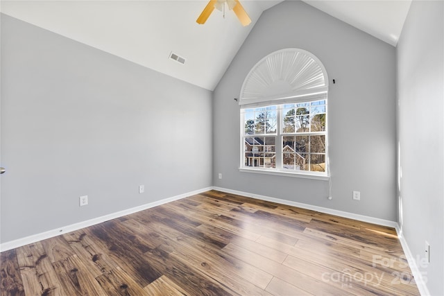 spare room featuring ceiling fan, hardwood / wood-style floors, and high vaulted ceiling