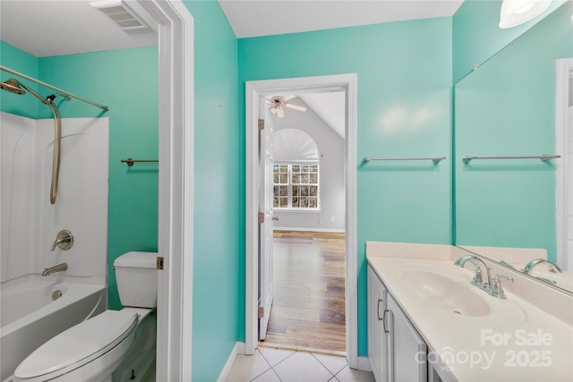 full bathroom with toilet, ceiling fan,  shower combination, tile patterned floors, and vanity