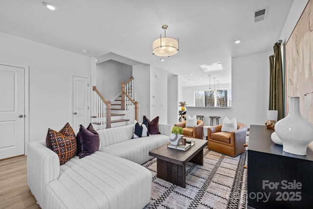 15310 Ballancroft Pkwy Unit 20, Charlotte, NC 28277 - living area featuring stairway, light wood-type flooring, and recessed lighting