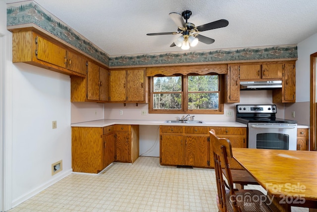 kitchen with ceiling fan, sink, a textured ceiling, and stainless steel range with electric cooktop