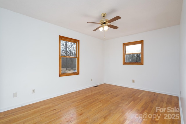 spare room featuring ceiling fan and light hardwood / wood-style flooring