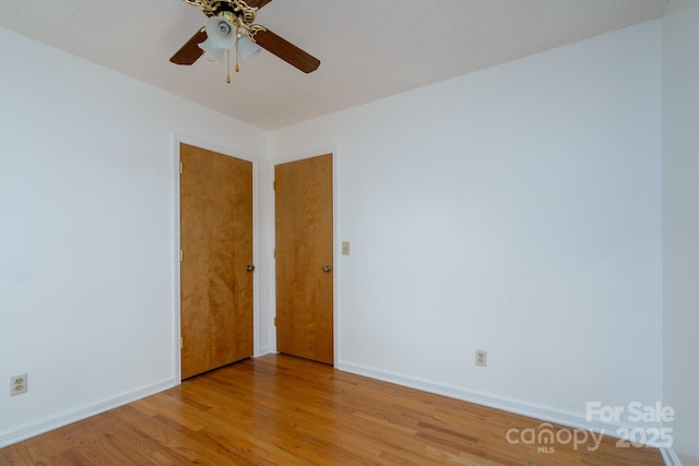 spare room featuring ceiling fan and light hardwood / wood-style flooring