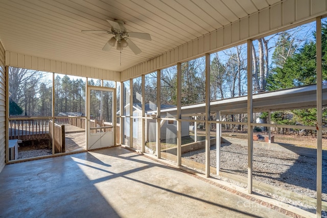 unfurnished sunroom featuring ceiling fan