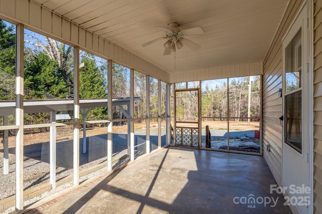 unfurnished sunroom with ceiling fan