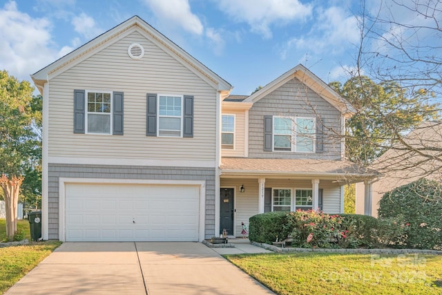 traditional-style home with a garage, concrete driveway, and a front yard