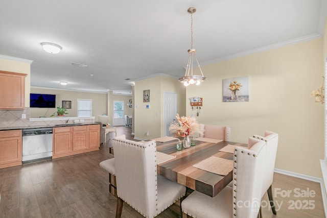 dining area with dark wood-style flooring, crown molding, and baseboards