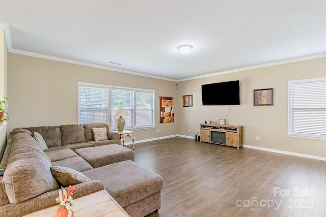 living room featuring baseboards, ornamental molding, and wood finished floors