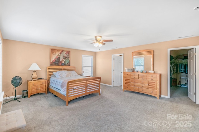 bedroom featuring multiple windows, light carpet, and baseboards