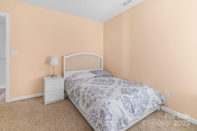 carpeted bedroom featuring visible vents and baseboards