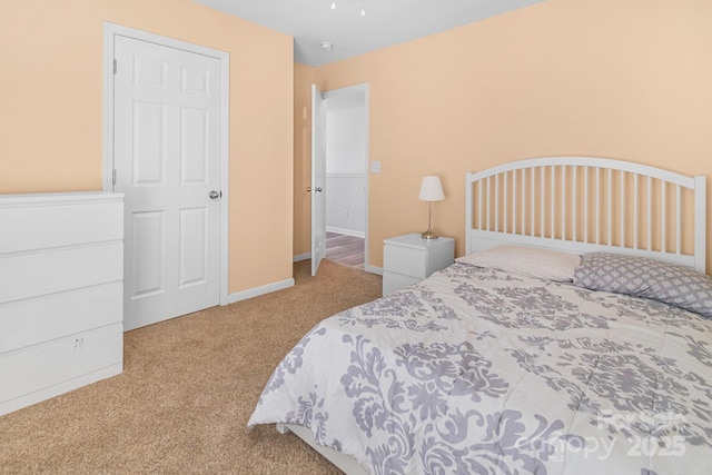 carpeted bedroom featuring baseboards