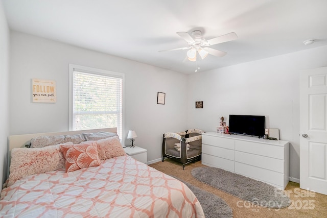 bedroom featuring light carpet, a ceiling fan, and baseboards