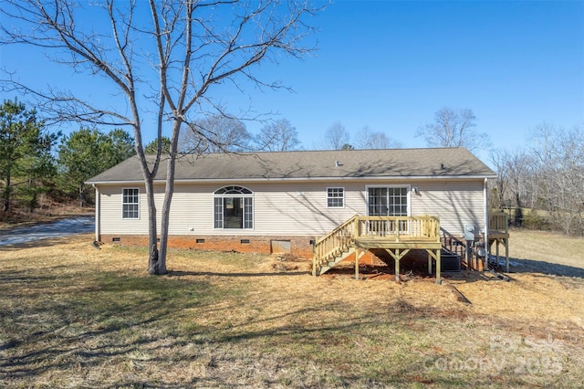 back of house featuring a lawn, central AC, and a wooden deck