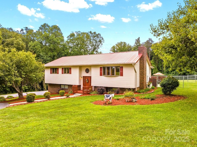 raised ranch with a front yard