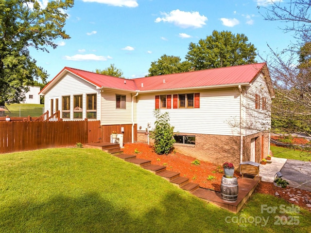 back of house featuring a lawn