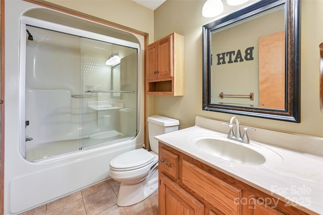 full bathroom with enclosed tub / shower combo, vanity, tile patterned floors, and toilet