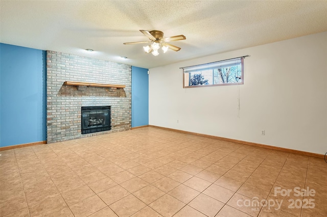 unfurnished living room with ceiling fan, a brick fireplace, and a textured ceiling