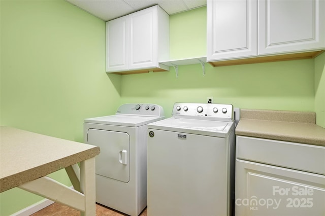 laundry area featuring cabinets and washer and clothes dryer