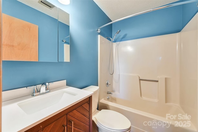 full bathroom with shower / tub combination, vanity, a textured ceiling, and toilet