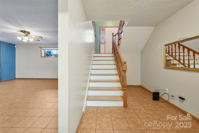 stairs featuring tile patterned flooring, a textured ceiling, and ceiling fan