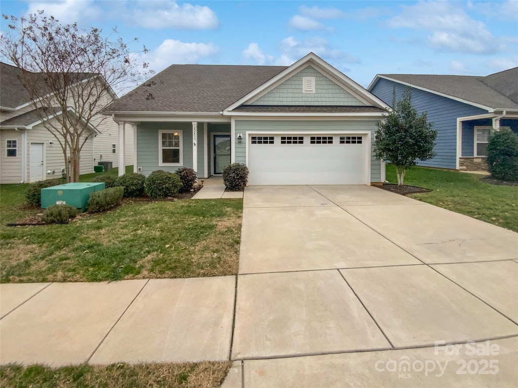 view of front facade featuring a garage and a front lawn