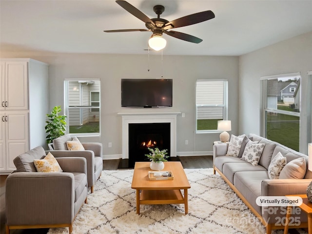 living room with ceiling fan and light hardwood / wood-style flooring