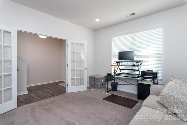 carpeted living room with french doors